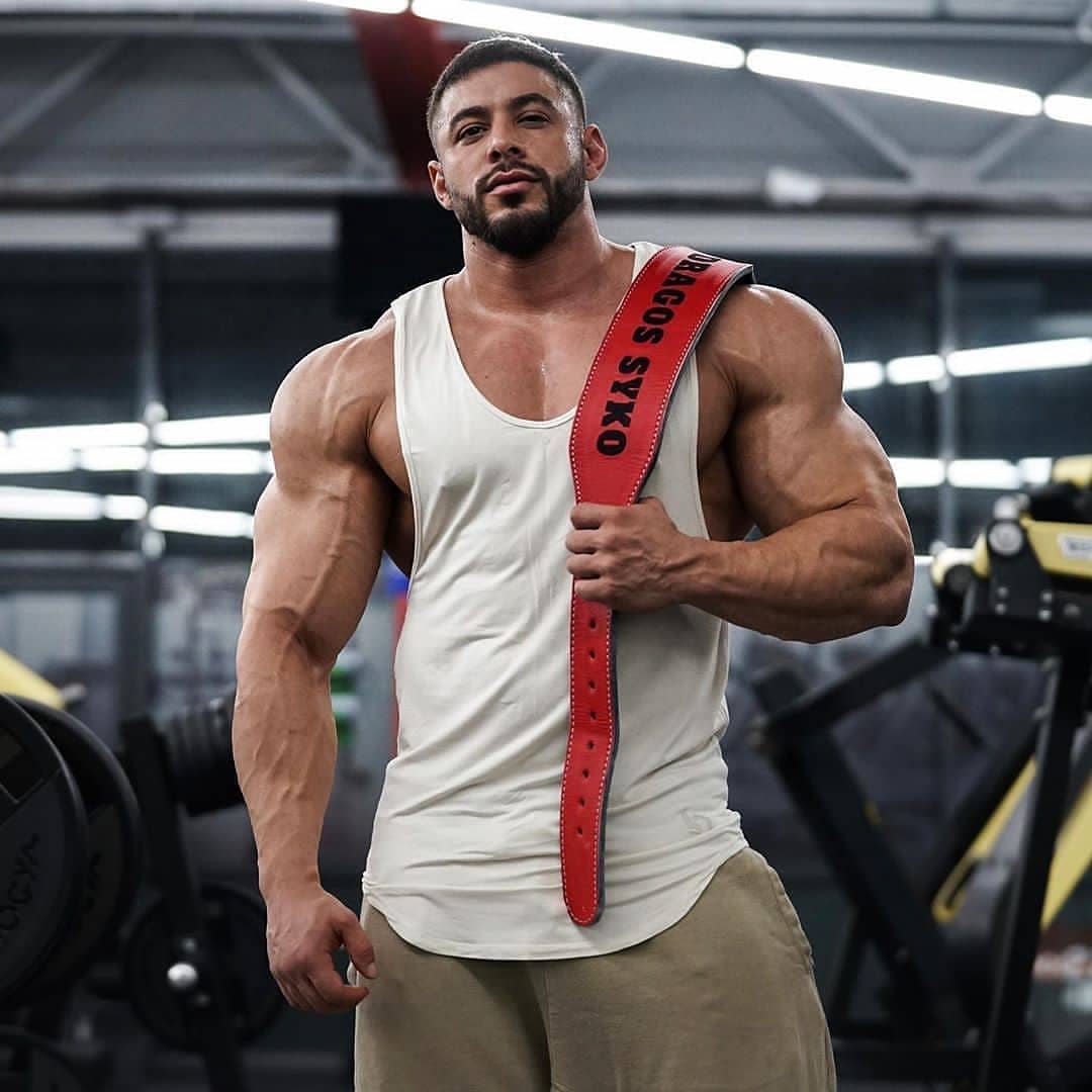 Athlete posing with his bespoke olympic custom belt over the shoulder