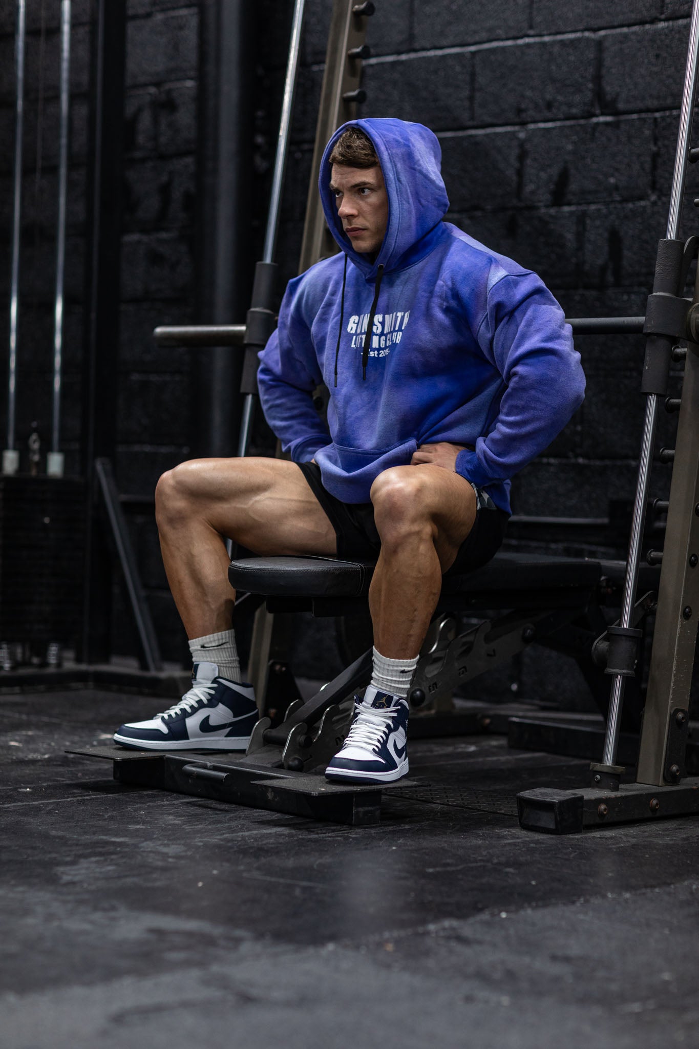 Athlete in the gym wearing the oversized acid wash gym hoodie in blue