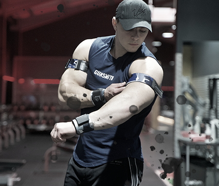 Athlete wearing Gunsmith Fitness blood flow restriction bands and wrist wraps